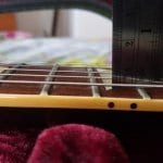 Check relief at 12th fret using steel rule or feeler gauge